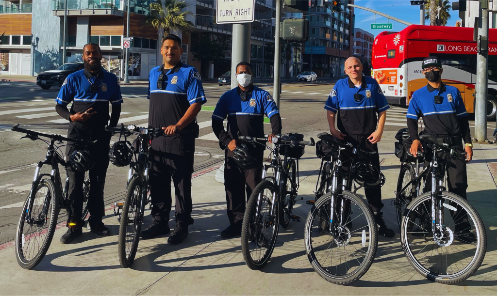 Five CSI patrol staff pose with their bicycles.